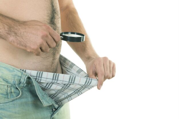 a man looks at his penis and wants to make it bigger